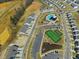 Aerial view of neighborhood featuring homes, tennis courts, pool, pond, and recreational areas at 1095 Channel Drop Lp, Zebulon, NC 27597