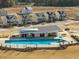 Community pool with sunshade, clubhouse and newly constructed single Gathering homes in the background at 1095 Channel Drop Lp, Zebulon, NC 27597