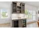 Kitchen bar area features custom cabinets, wine storage, and stylish lighting at 1112 Watauga Street St, Raleigh, NC 27604