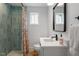 Bathroom featuring a modern vanity, shower with blue tile, and neutral decor at 1112 Watauga Street St, Raleigh, NC 27604
