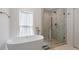 Bright bathroom features a freestanding tub, glass-enclosed shower, and modern fixtures at 1112 Watauga Street St, Raleigh, NC 27604