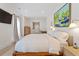 Bright bedroom features white walls, wooden floors, modern furnishings, and a large painting at 1112 Watauga Street St, Raleigh, NC 27604