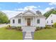 Charming white home with a welcoming front porch and landscaped yard at 1112 Watauga Street St, Raleigh, NC 27604