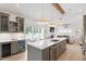 Kitchen with bar, wine coolers, and a large island that opens into the dining and living area at 1112 Watauga Street St, Raleigh, NC 27604