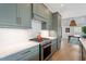 Charming kitchen showcases updated appliances and elegant countertops with plenty of storage at 1112 Watauga Street St, Raleigh, NC 27604