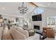 Open-concept living room with fireplace, hardwood floors, and abundant natural light at 1112 Watauga Street St, Raleigh, NC 27604