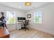 Home office with two windows, desk, office chair, and hardwood flooring at 1112 Watauga Street St, Raleigh, NC 27604