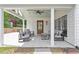 Covered patio has ceiling fan, wood ceiling, and outdoor seating area at 1112 Watauga Street St, Raleigh, NC 27604