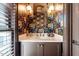 Chic powder room with bold wallpaper, marble countertop, and elegant fixtures at 1112 Watauga Street St, Raleigh, NC 27604