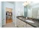 Bathroom with double sink vanity, granite countertop, and an open walk-in closet at 112 Manning Way, Durham, NC 27703