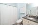 Bathroom with granite countertops, and a shower and tub combo behind a white shower curtain at 112 Manning Way, Durham, NC 27703