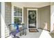 Cozy front porch featuring stylish furniture, a decorative wreath, and a welcoming ambiance at 112 Manning Way, Durham, NC 27703