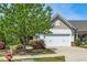 Charming home featuring a two-car garage, manicured landscaping, and an inviting walkway at 112 Manning Way, Durham, NC 27703