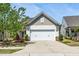 Charming home featuring a two-car garage, beautiful landscaping, and inviting curb appeal at 112 Manning Way, Durham, NC 27703