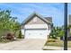 Lovely home featuring a two-car garage, manicured landscaping, and an inviting driveway at 112 Manning Way, Durham, NC 27703