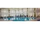 Bright indoor pool area featuring ample windows and comfortable seating for residents at 112 Manning Way, Durham, NC 27703