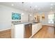 Beautiful kitchen featuring an island, granite countertops, stainless steel appliances, and hardwood floors at 112 Manning Way, Durham, NC 27703