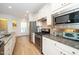 Modern kitchen showcases stainless steel appliances, granite countertops, ample cabinetry, and seamless flow to other living spaces at 112 Manning Way, Durham, NC 27703