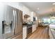 Modern kitchen featuring stainless steel appliances, granite countertops, and white cabinetry at 112 Manning Way, Durham, NC 27703