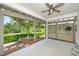 Relaxing covered patio with a ceiling fan, offering a private outdoor space for entertaining and enjoying the landscaped yard at 112 Manning Way, Durham, NC 27703