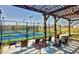 Shaded outdoor seating area overlooking the vibrant tennis courts for residents' enjoyment at 112 Manning Way, Durham, NC 27703