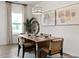 Bright dining room with hardwood flooring, modern chandelier, decorative pictures, and lots of light at 115 N District Ave # 298, Clayton, NC 27527