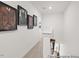 Well-lit hallway adorned with framed artwork, carpet flooring, and white walls at 115 N District Ave # 298, Clayton, NC 27527