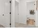 Hallway view with access to the bathroom with tile flooring and fresh paint at 115 N District Ave # 298, Clayton, NC 27527