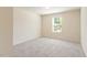 Bright, carpeted bedroom featuring a window with blinds and ample space at 1175 Contessa Dr, Cary, NC 27513