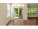 Bright dining area with hardwood floors and sliding glass doors leading to a patio at 1175 Contessa Dr, Cary, NC 27513