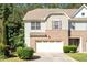 Charming brick and siding townhome with an attached garage and manicured landscaping at 1175 Contessa Dr, Cary, NC 27513