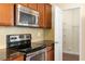 Modern kitchen with stainless steel appliances, granite countertops and ample storage at 1175 Contessa Dr, Cary, NC 27513