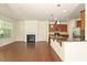 Open-concept living room featuring a fireplace, hardwood floors and a kitchen with a breakfast bar at 1175 Contessa Dr, Cary, NC 27513