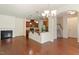 Open-concept living room with a fireplace, hardwood floors, and a kitchen with a breakfast bar at 1175 Contessa Dr, Cary, NC 27513