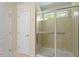 Modern shower with beige tiles and glass doors at 1175 Contessa Dr, Cary, NC 27513