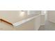 Carpeted staircase features a white railing and neutral walls at 1175 Contessa Dr, Cary, NC 27513