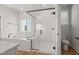 Modern bathroom with glass shower, tub, and sleek fixtures at 1306 Cricket St, Elon, NC 27244