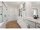 Bathroom featuring double sink vanity, white cabinets, and tiled shower at 1306 Cricket St, Elon, NC 27244