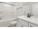 Clean bathroom showcasing a tub with shower, single vanity, and white fixtures at 1306 Cricket St, Elon, NC 27244