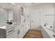 Bright bathroom featuring a double sink vanity, stylish fixtures, and a separate soaking tub at 1306 Cricket St, Elon, NC 27244