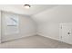 Bedroom featuring neutral carpet, natural light, and view of the home next door at 1306 Cricket St, Elon, NC 27244
