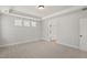 Bedroom featuring plush carpet, tray ceiling and an ensuite bathroom with dual closets at 1306 Cricket St, Elon, NC 27244