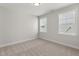 Bedroom with carpeted floors, two windows, and neutral wall colors at 1306 Cricket St, Elon, NC 27244