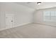 Empty bedroom featuring neutral carpet, natural light, and a window view at 1306 Cricket St, Elon, NC 27244