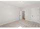 Bedroom featuring carpeted floors, white trim and an open door to a bathroom at 1306 Cricket St, Elon, NC 27244