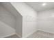 Walk-in closet with ample storage space and shelving at 1306 Cricket St, Elon, NC 27244