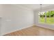 Bright dining area featuring wood floors and a large window with views of the landscaped yard at 1306 Cricket St, Elon, NC 27244