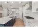 Open concept kitchen with stainless steel appliances, stylish hood, and gas range at 1306 Cricket St, Elon, NC 27244