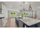 Kitchen island with stainless steel dishwasher and open windows overlooking the backyard at 1306 Cricket St, Elon, NC 27244
