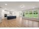 A bright living room features hardwood floors and an island kitchen at 1306 Cricket St, Elon, NC 27244